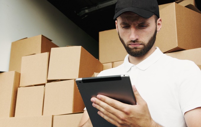 Man With Boxes Behind Him