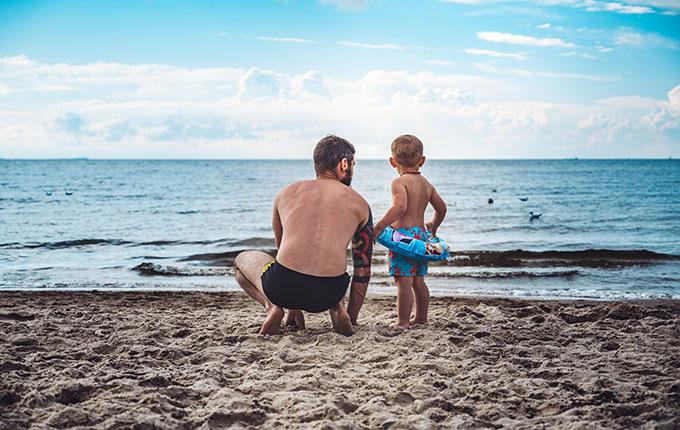 Dad and child at beach