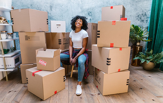 Woman surrounded by cardboard boxes