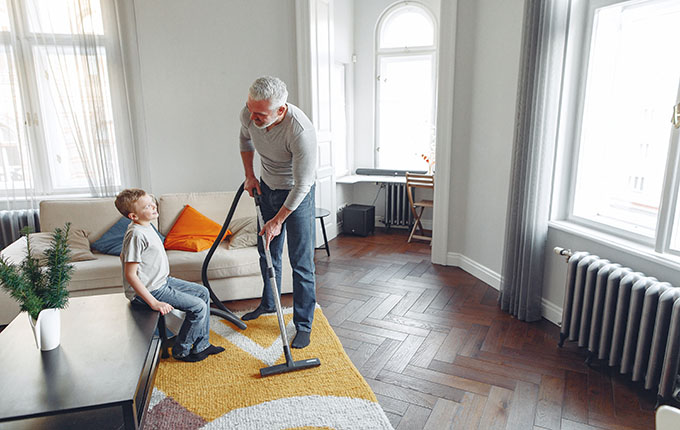 Father Vacuuming with Son