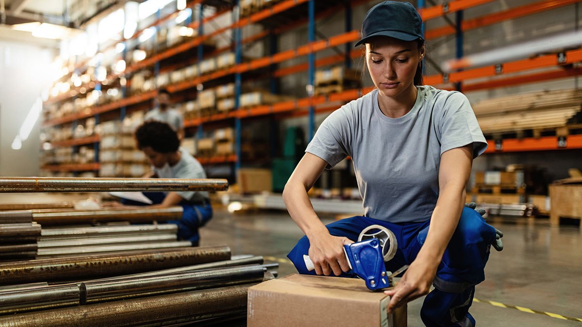 Warehouse worker taping a consolidated package
