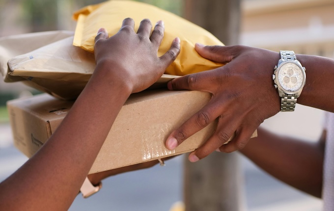 person handing over packages