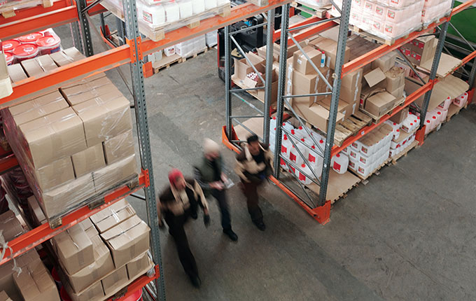 Men walking in a warehouse