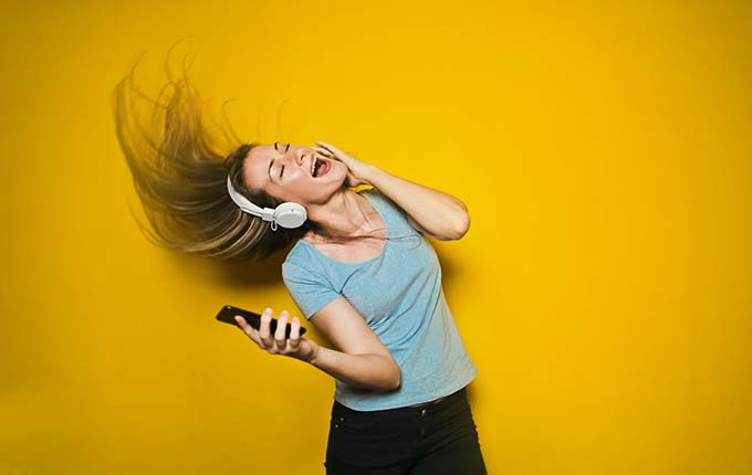 Image of woman dancing while wearing headphones